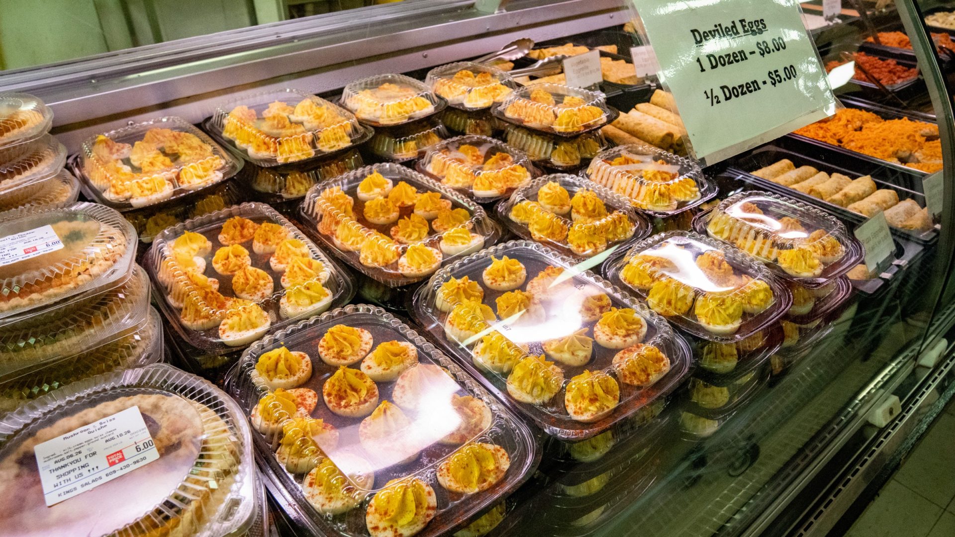 Deli case of deviled eggs and prepared salads
