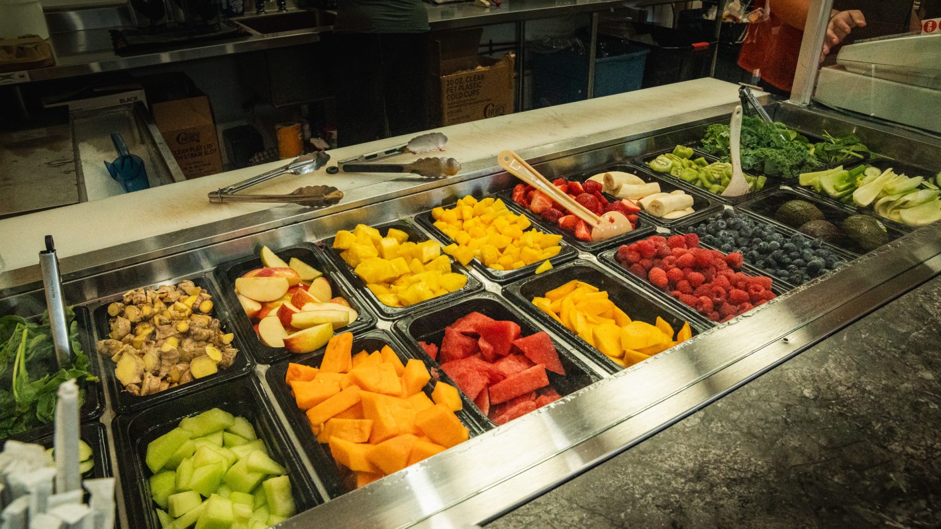 Fresh-cut fruit bar with melon, berries, mango, and pineapple